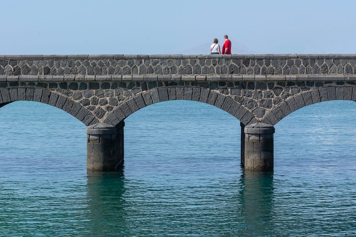 Walkers on the Puente de las Bolas in Arrecife