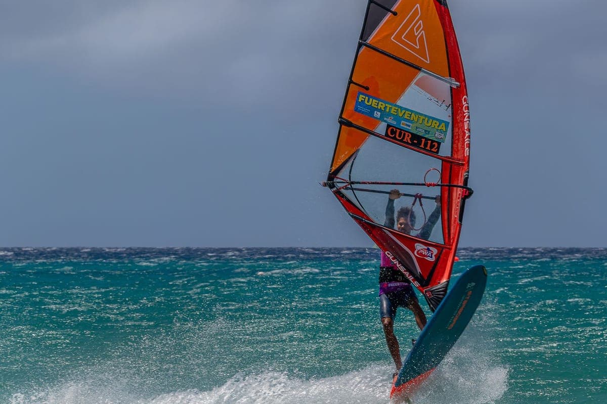 Windsurfer with a Fuerteventura sail racing across the waves