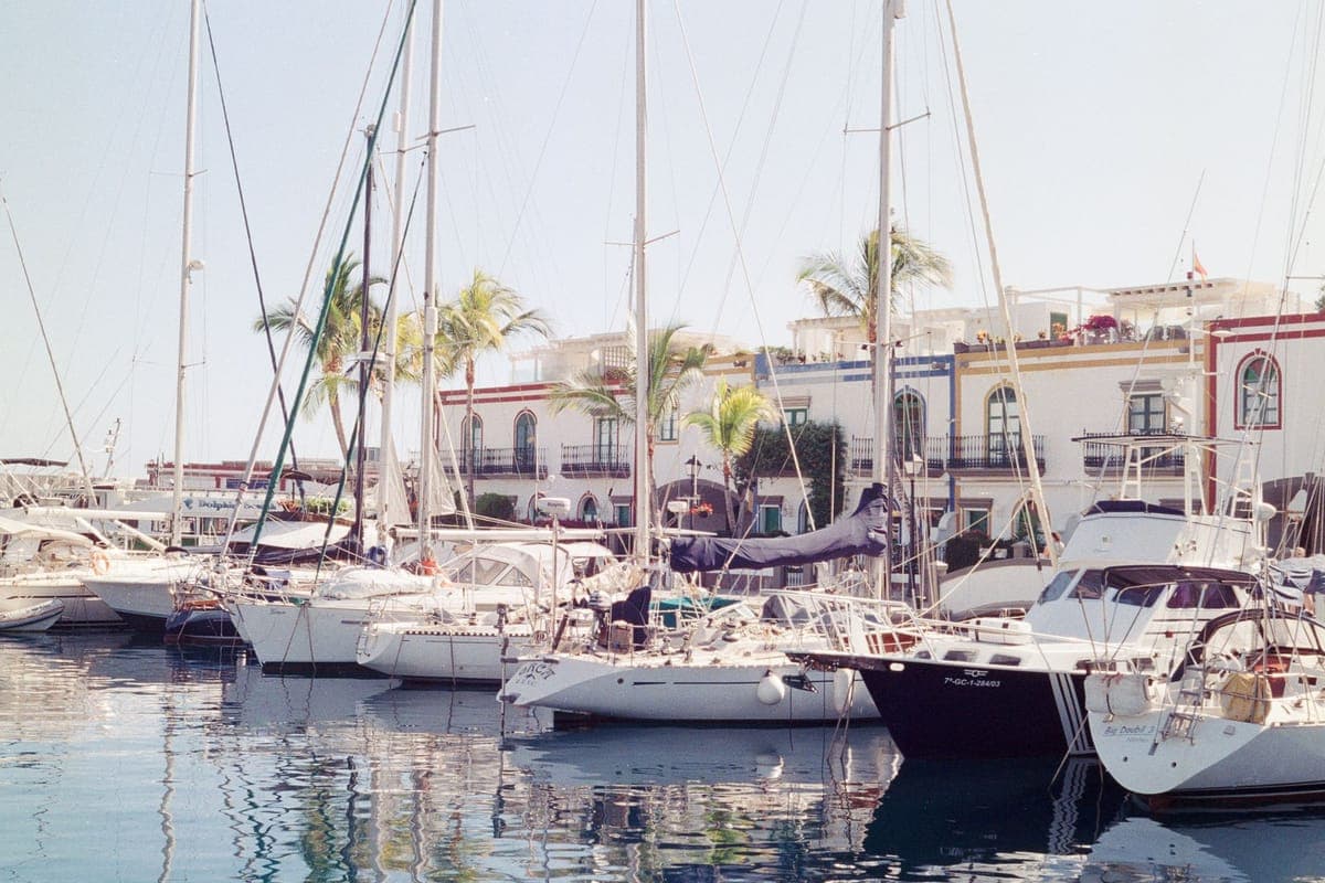 Yachts in Puerto de Mogán marina with white-walled houses behind