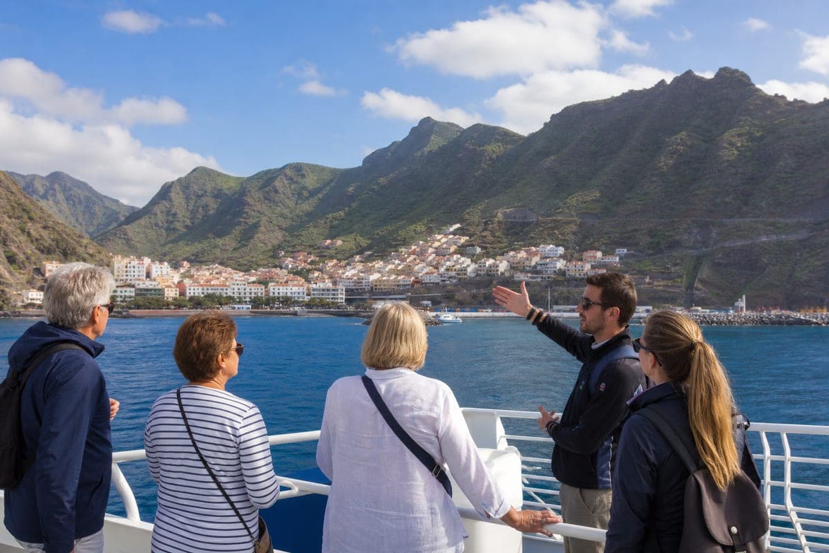 Guided day-trip group arriving by ferry at mountainous La Gomera