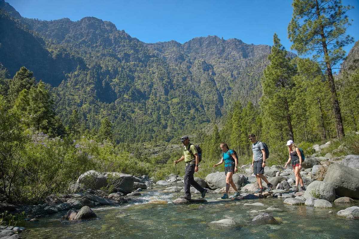 Guided hikers crossing a stream in La Palma's Caldera de Taburiente