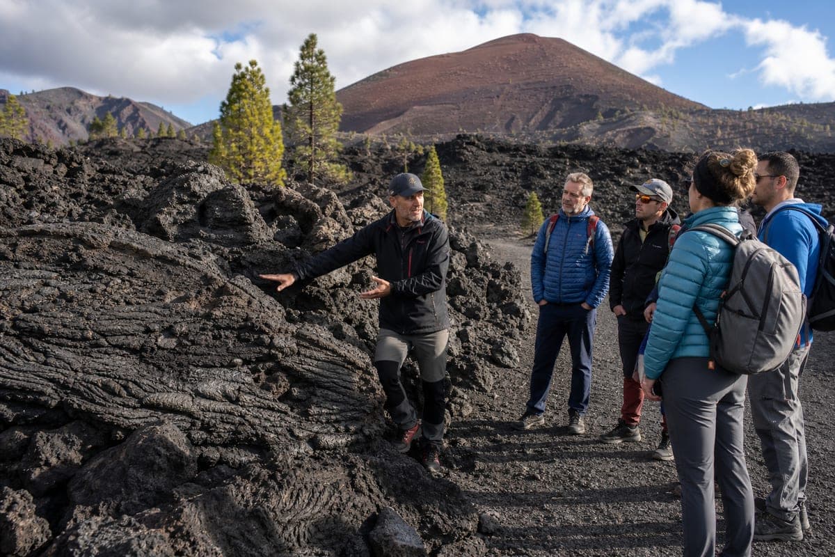 Volcanologist explaining solidified lava on La Palma's Tajogaite eruption route