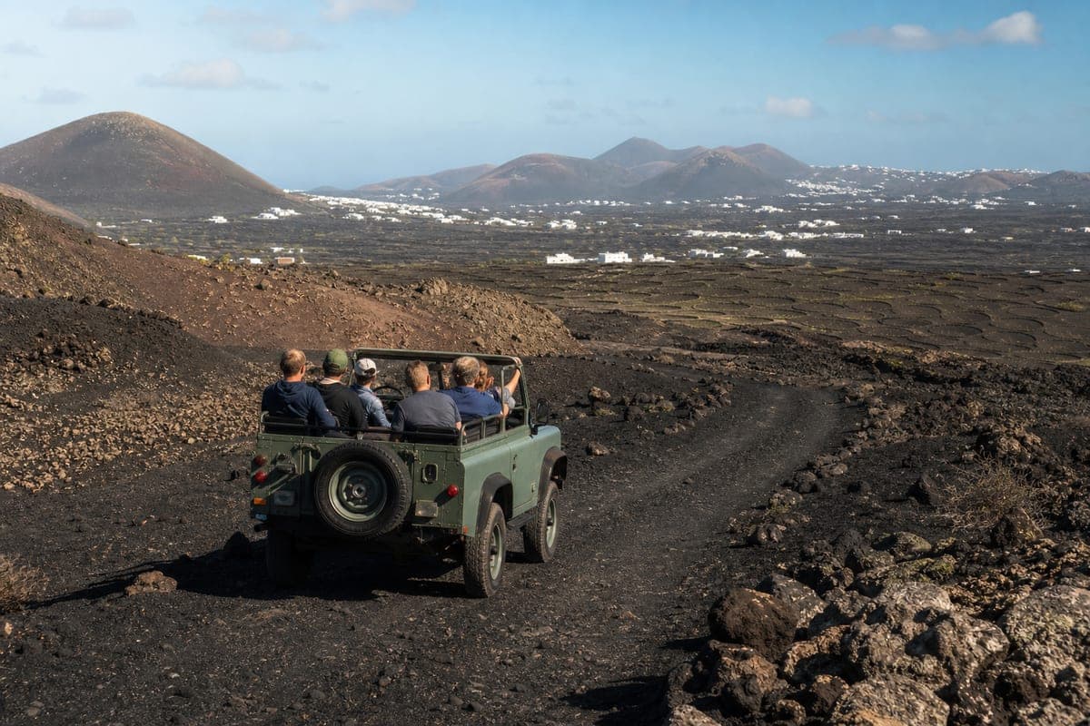 Guided four-wheel-drive tour crossing a volcanic track in southern Lanzarote